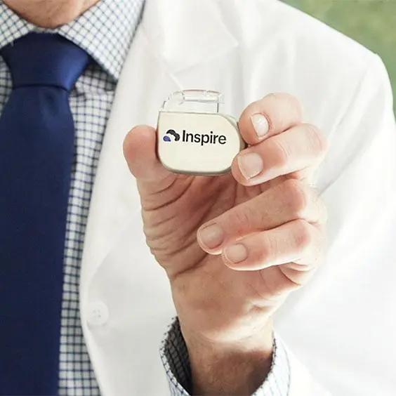 Physician holding Inspire therapy device